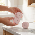 SnapPods pink magnetic capsules snapping together on marble vanity